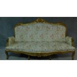 A 19th century rococo style giltwood three seat canape with shell carved cresting back rail and