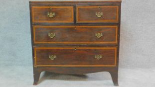 A small Regency mahogany and satinwood crossbanded chest of two short over two long drawers on swept