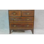 A small Regency mahogany and satinwood crossbanded chest of two short over two long drawers on swept