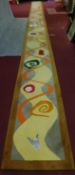 An extremely long runner, polychrome abstract decoration, inset brass and mesh panels. 93x1300cm