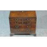 A Georgian Cuban mahogany bureau with fall front revealing fitted interior above four long drawers