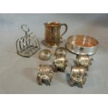 Silver wine coaster, tankard, toast rack, napkin rings and White metal napkin rings, four white