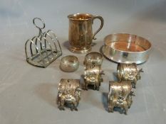 Silver wine coaster, tankard, toast rack, napkin rings and White metal napkin rings, four white