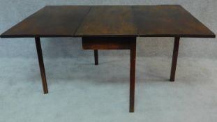 A Georgian mahogany drop flap dining table on square section supports. H.72 W.152 D.111cm