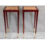 A pair of chess top inlaid occasional tables on tapering square section supports terminating in