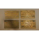 A collection of four brass wall plates for the Wesleyan and General Assurance Society. H.20cm W.35cm