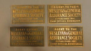 A collection of four brass wall plates for the Wesleyan and General Assurance Society. H.20cm W.35cm