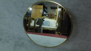 a circular gilt framed wall hanging mirror D.76cm
