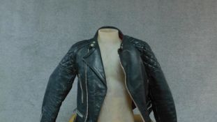 A vintage leather motorcycle jacket. (small size).