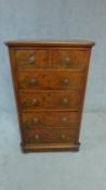 A 19th century walnut tall chest of drawers of narrow proportions. H.110cm W.66cm D.40cm