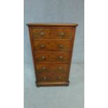 A 19th century walnut tall chest of drawers of narrow proportions. H.110cm W.66cm D.40cm