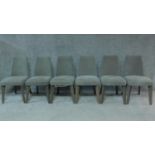 A set of six contemporary dining chairs in grey calico upholstery on splay supports. H.87cm