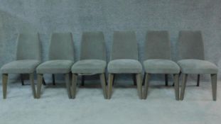 A set of six contemporary dining chairs in grey calico upholstery on splay supports. H.87cm