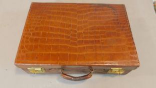 A vintage crocodile skin travel case. H.16cm W.51cm D.35cm