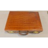 A vintage crocodile skin travel case. H.16cm W.51cm D.35cm