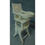 A late 19th century painted metamorphic child's high chair converting to a rocking chair. H.98cm