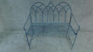 A metal garden bench with triple Gothic arched back. H. 100cm W 102cm D. 48cm