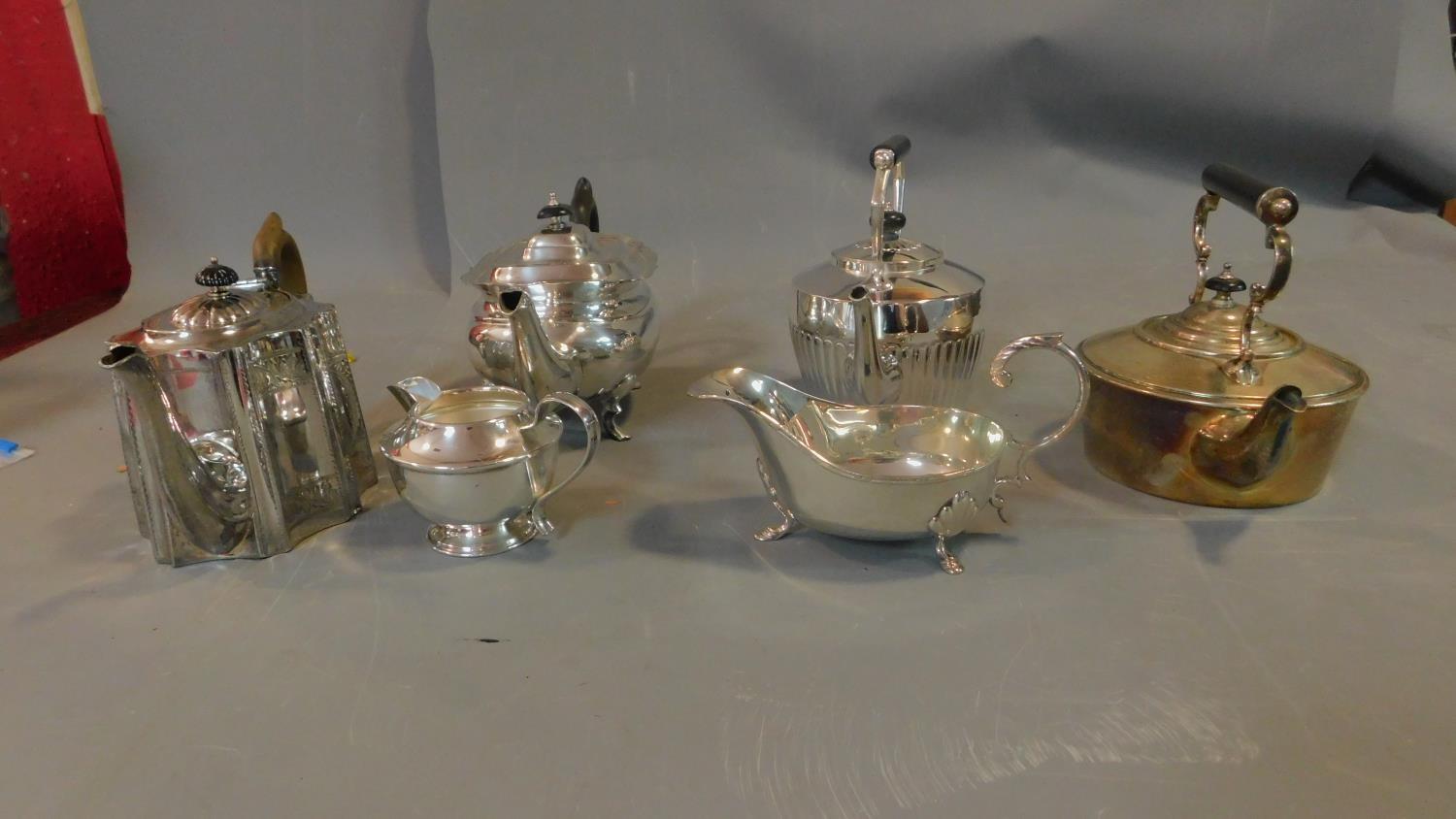 A collection of silver plated tea pots and jugs and a brass kettle, some with ebony handles. - Image 2 of 7