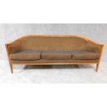 A mid 20th century Danish teak three seater sofa in tobacco calico upholstery. H. 71cm W. 197cm D.