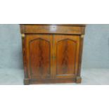 A Regency mahogany two door chiffonier with arched panel doors flanked by pilasters. H.92cm W.92cm