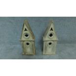 A pair of distressed painted Gothic style bird houses. H.52cm