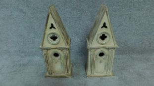 A pair of distressed painted Gothic style bird houses. H.52cm