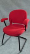 A Herman Miller metal framed office armchair in red upholstery. H.84cm