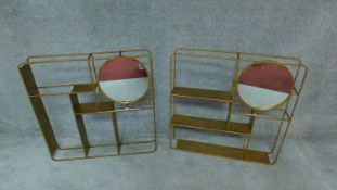 A pair of gilt metal framed wall shelves fitted with circular swing mirrors. H.80cm W.80cm