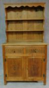 A Jacobean style oak dresser with plate rack above base fitted with drawers and cupboards. H.171 W.