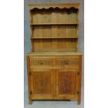 A Jacobean style oak dresser with plate rack above base fitted with drawers and cupboards. H.171 W.