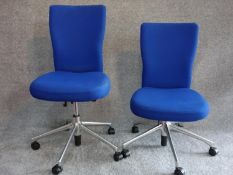 A pair of blue upholstered swivel chairs, Vitra label to base. H.102