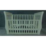 A contemporary white painted child's cot. H.98cm W.140cm D.67cm