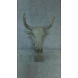 A moulded bust of a bull's head on plinth base H.113cm