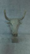 A moulded bust of a bull's head on plinth base H.113cm