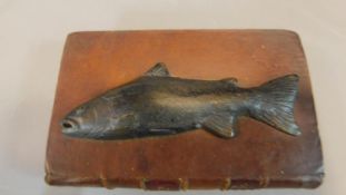 A desk paperweight in the form of Isaac Walton's the complete angler. W.14cm D.9cm