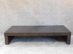 A contemporary low coffee table on block supports. H.30 W.150 D.70cm