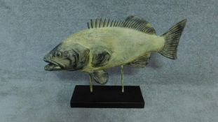 A large model of a fish on black metal stand. H. 45cm W 64cm