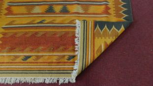 A multicoloured woven kelim with allover geometric design. L. 246cm W. 164cm