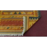 A multicoloured woven kelim with allover geometric design. L. 246cm W. 164cm