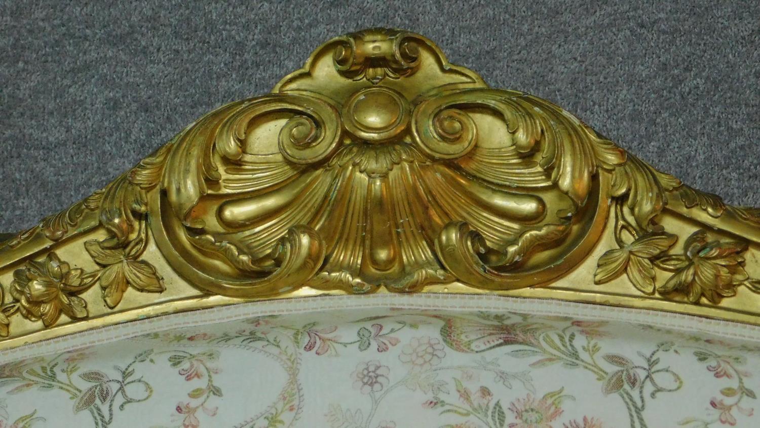 A 19th century rococo style giltwood three seat canape with shell carved cresting back rail and - Image 2 of 10