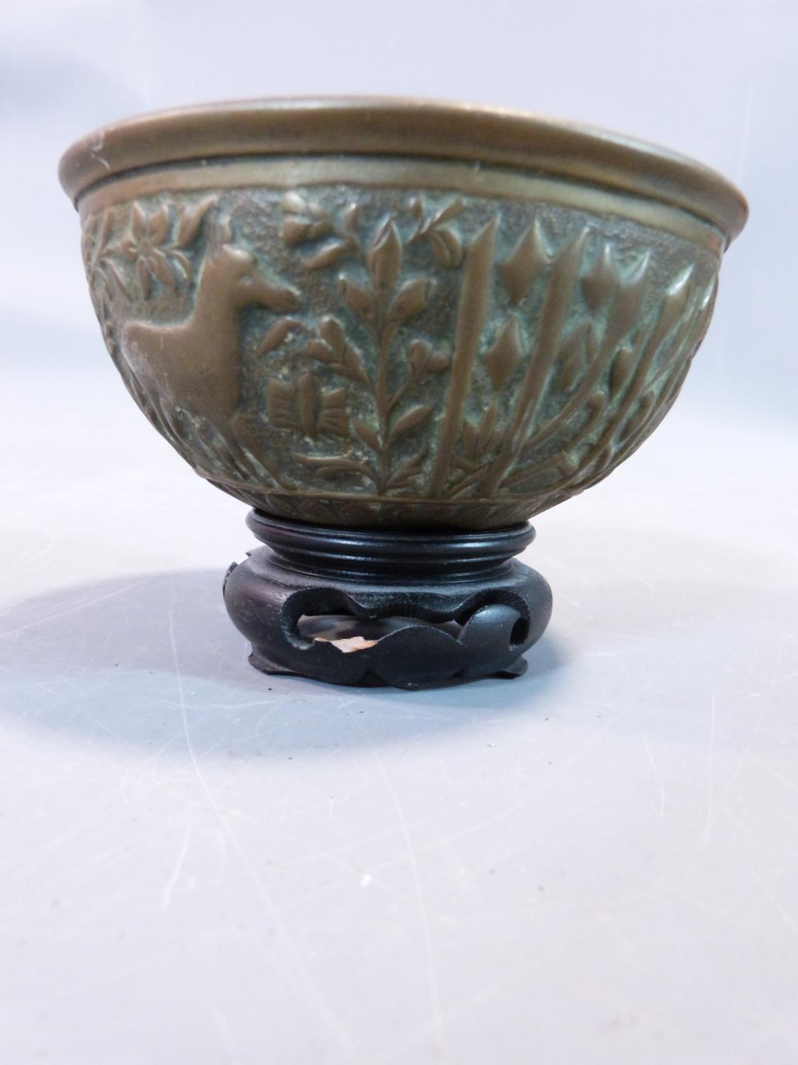 A tribal wooden foot carving and an Indian brass bowl with repousse animal design and a wooden stand - Image 9 of 10