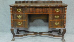 An early 20th century walnut Dutch style kneehole writing desk H.77 W.115 D.46cm