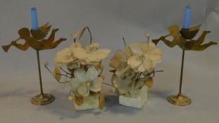 A pair of brass cherub candlesticks and a pair of mother of pearl flower arrangements. H.40cm (