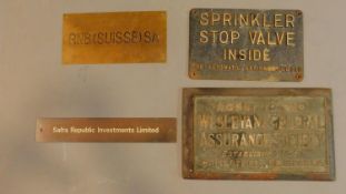 A collection of four miscellaneous brass wall plates. H.26cm W.42cm