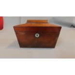 A Regency mahogany two section sarcophagus shaped tea caddy. H.15cm W.23cm D.12cm (lid detached)