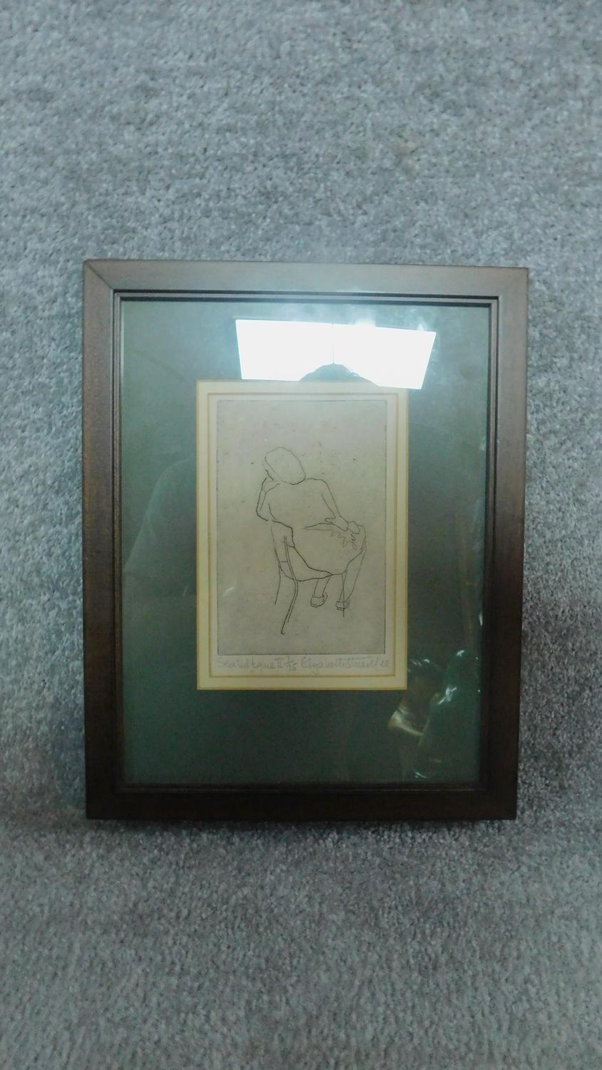 A framed and glazed limited edition etching of a seated figure, signed Elizabeth Stuart Lee,