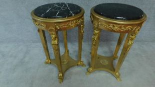 A pair of Empire style gilt jardiniere stands with circular grey veined marble tops. H. 85cm D. 54