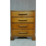 A mid 20th century Art Deco style oak chest of four long drawers on carved bracket feet. H.95 W.75