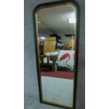 A black painted and gilt decorated rococo style cheval mirror on easel stand. H. 163cm