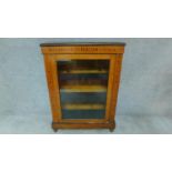 A Victorian walnut and satinwood inlaid pier cabinet with single glazed door. H.104 W.75 D.29
